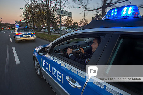 Police patrol car in an emergency operation  with blue lights and sirens  Germany  Europe