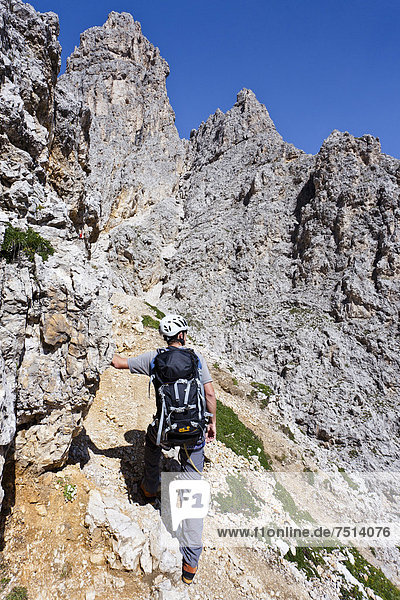 Mountain climber ascending to the summit of Plattkofel Mountain via the Oskar-Schuster climbing route  Dolomites  Alto Adige  Italy  Europe