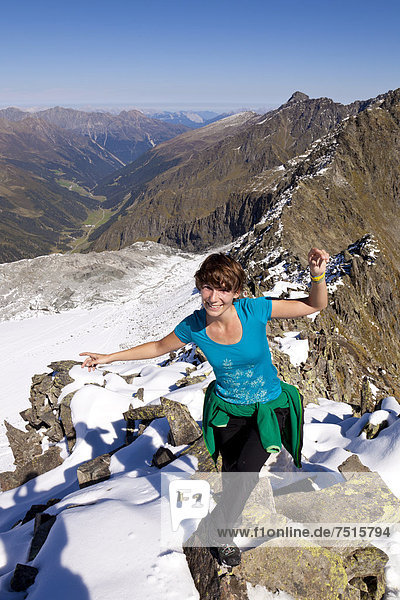 Mountain climber balancing on the ridge of Rinnenspitze Mountain  Stubai Alps  Tyrol  Austria  Europe