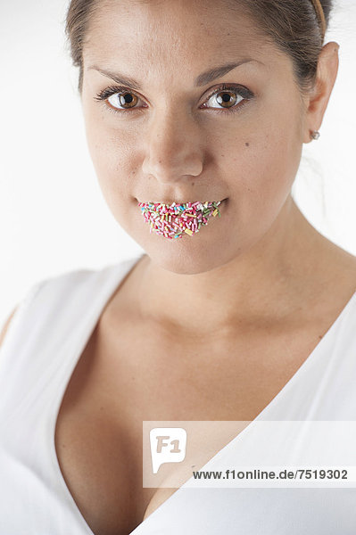 Portrait of woman with colorful sprinkles on her lips