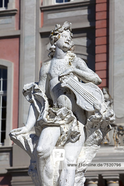 Baroque statue holding a musical instrument in front of the Electoral Palace in Trier  Rhineland-Palatinate  Germany  Europe