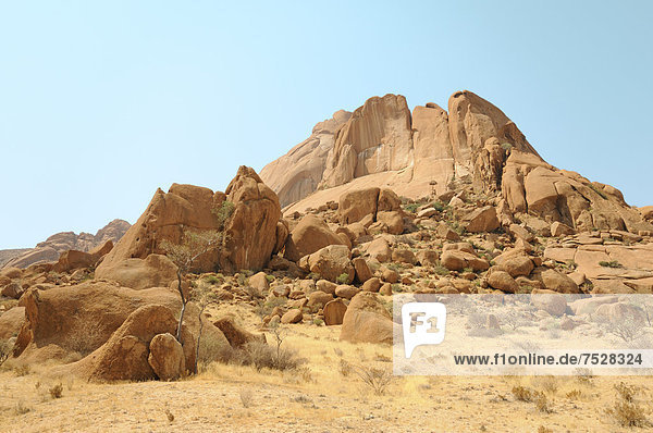 Savannah landscape with granite rocks and Spitzkoppe Mountain