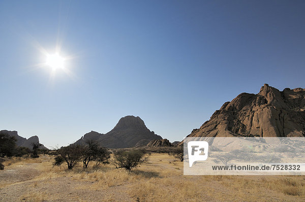 Savannah landscape with granite rocks and Spitzkoppe Mountain