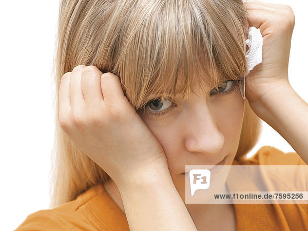 Young woman holding a tissue  angry  sad