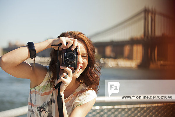 Woman taking picture by city cityscape