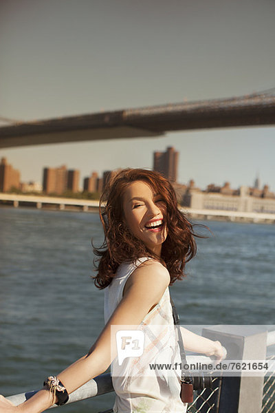 Smiling woman at urban waterfront