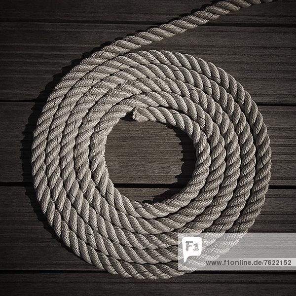 Rope coiled into circle on boardwalk