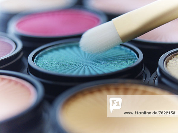 Close up of makeup brush with eyeshadows