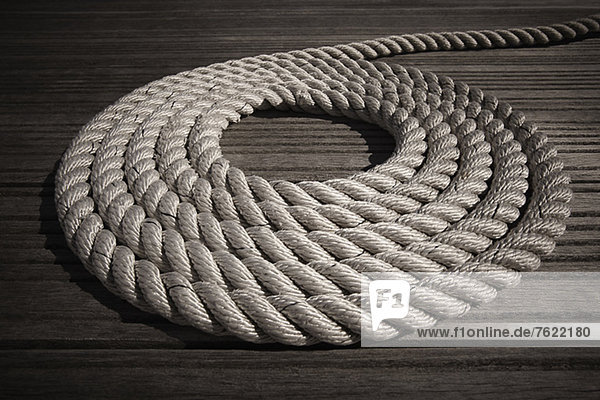 Rope coiled in circle on boardwalk
