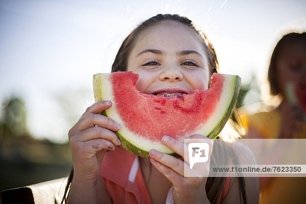 Smiling girl eating watermelon