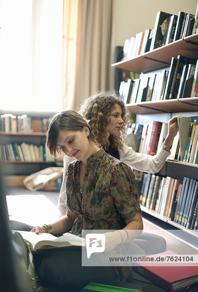 Students reading books in library