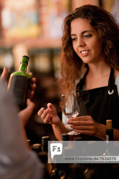 Server taking glass for wine tasting