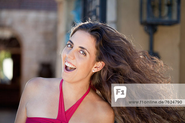 Smiling woman tossing her hair