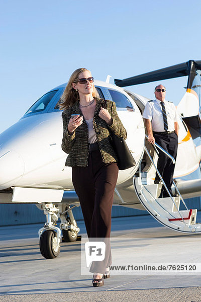 Businesswoman on airplane runway