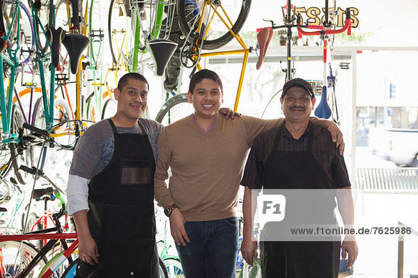 Mechanics smiling in bicycle shop