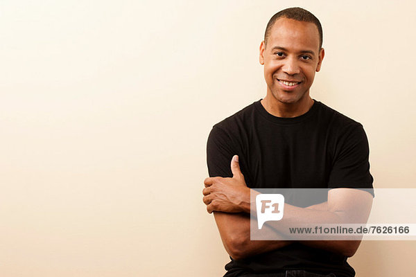 Smiling man standing with arms crossed