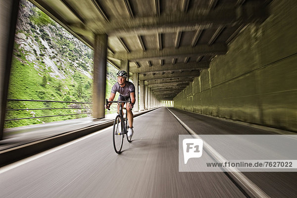 Racing cyclist on mountain pass road  Andermatt  Switzerland