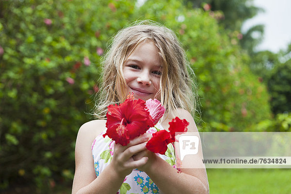 Caucasian girl holding red flowers