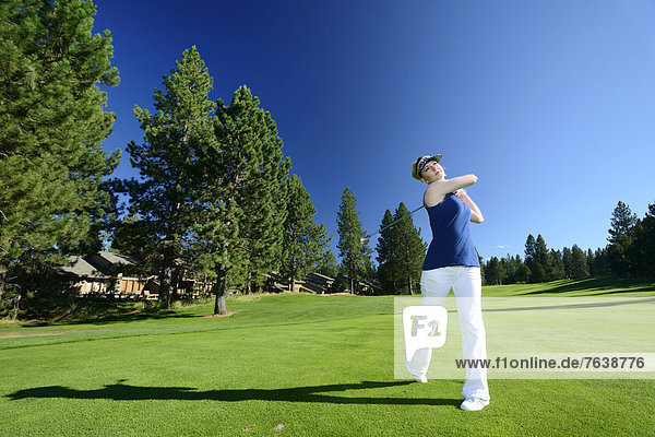 Oregon  USA  United States  America  Pacific Northwest  woman  golf  golfer  white pants  green  lawn  sport  resort