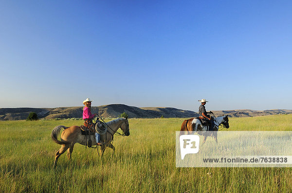 Pacific Northwest  American west  Oregon  USA  United States  America  cowgirl  girl  woman  cowboy  prairie  grassland  riding  horse  range
