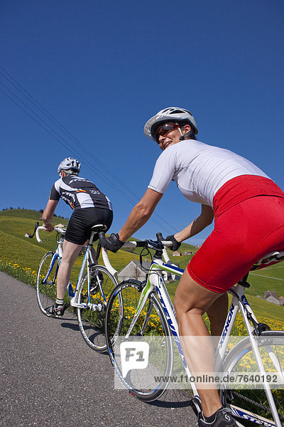 Cyclist  biker  Appenzell area  spring  bicycle  bicycles  bike  riding a bicycle  canton  Appenzell  Innerroden  Alpstein  Säntis  racing bicycle  Switzerland  Europe  spring  couple  man  woman  Gonten