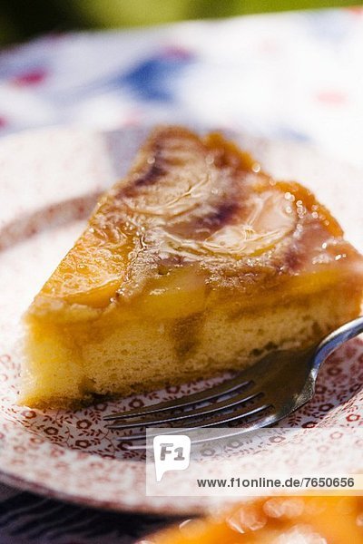 'A Slice of Peach Upside Down Cake on a Plate