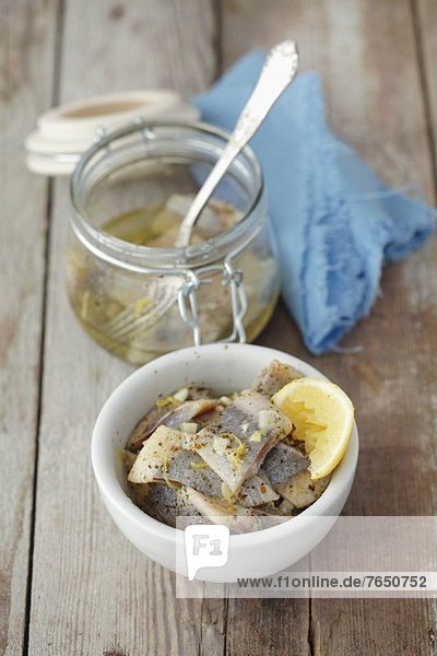 Preserved herrings in oil with lemons  garlic and marjoram