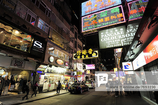 Neon signs on a street in Tsim Sha Tsui at night  Kowloon  Hong Kong  China  Asia