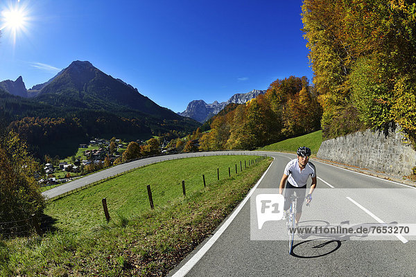 Cyclist riding along the Hochalpenstrasse  a high alpine road between Bischofswiesen and Berchtesgaden  Upper Bavaria  Bavaria  Germany  Europe