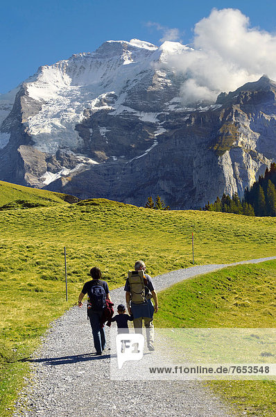 Family walking  Grindelwald First  Swiss Alps  Switzerland  Europe