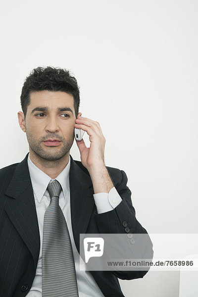 Mid-adult businessman talking on cell phone