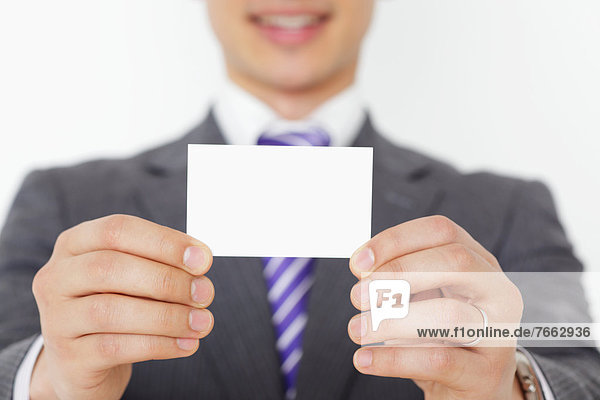 Businessman holding a business card