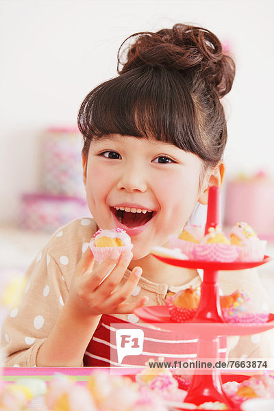 Young girl in a kitchen smiling at camera