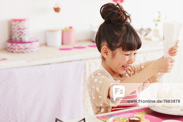 Young girl making a cake