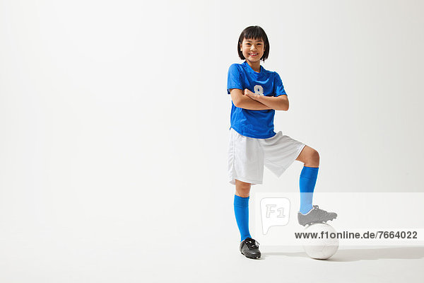 Girl Posing In Soccer Uniform With Ball