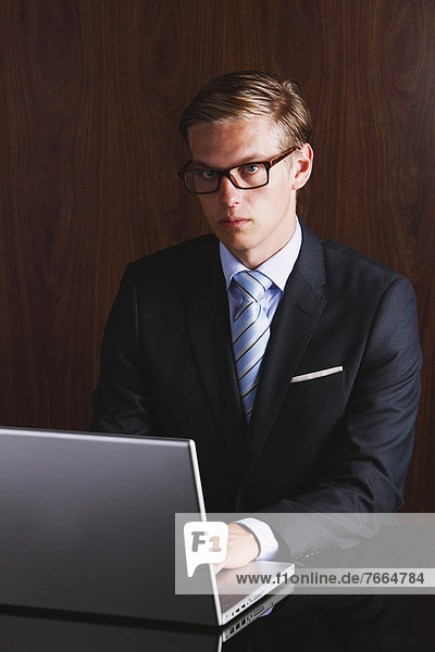 Businessman with glasses using laptop
