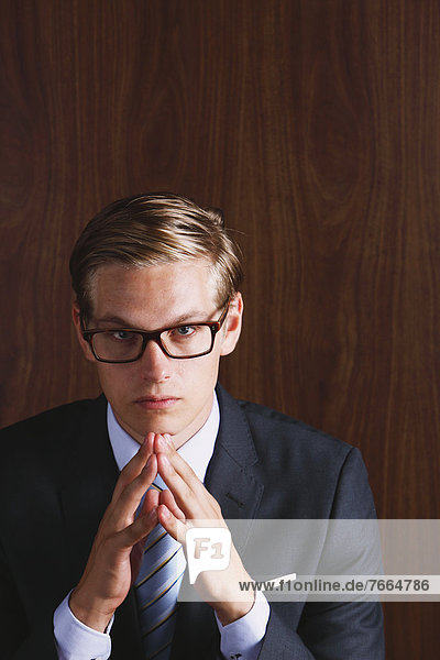 Businessman with glasses looking at camera