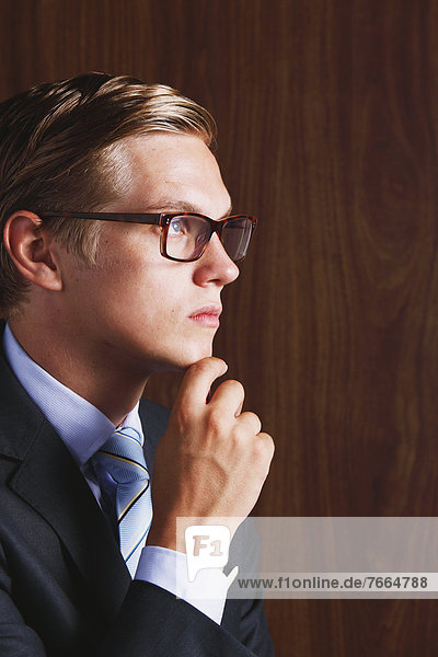 Businessman with glasses looking away