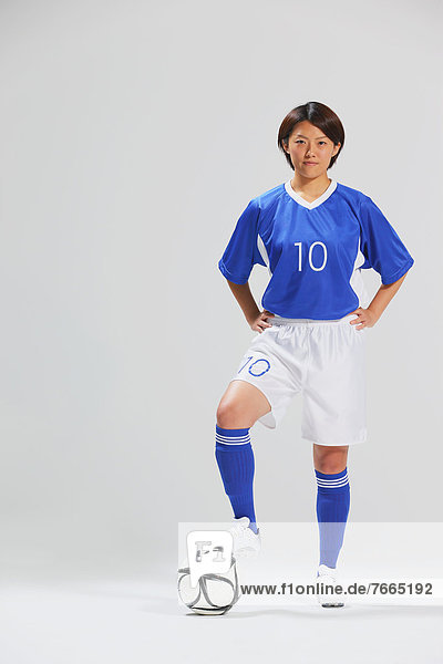Woman In Soccer Uniform Posing With Ball