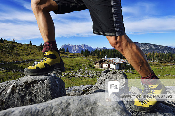 Hikers at the Eggenalm mountain pasture  detail view of his legs  Reit im Winkl  Chiemgau region  Upper Bavaria  Bavaria  Germany  Europe