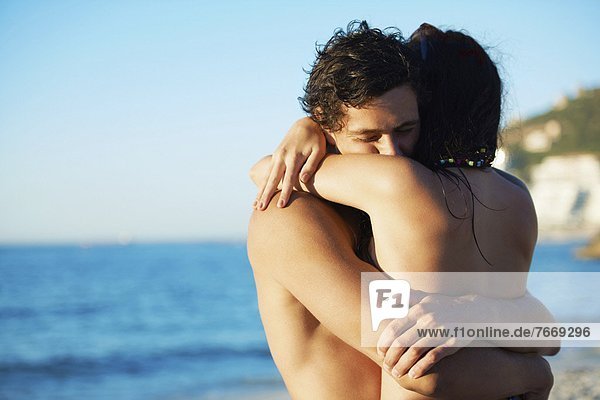 Young couple hugging at beach