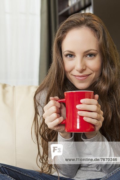 Portrait of smiling woman holding mug