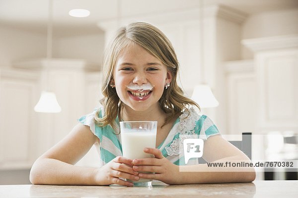 Girl (6-7) drinking milk