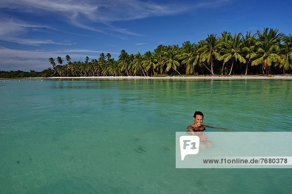 Dominican Republic  national Park de Este  Isla Sahona  girl showing seastar                                                                                                                            
