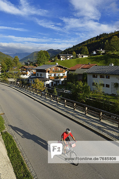 Cyclist riding on a road  Ramsau  Berchtesgaden  Upper Bavaria  Bavaria  Germany  Europe