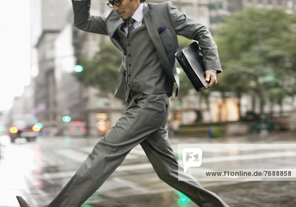 Businessman crossing city street