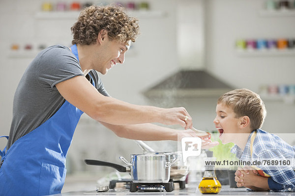 Father and son cooking in kitchen