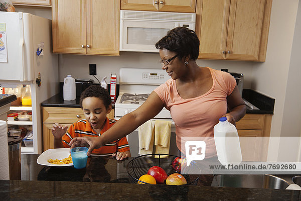 Mother making lunch for son in kitchen