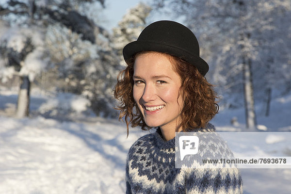 Caucasian woman smiling in snow
