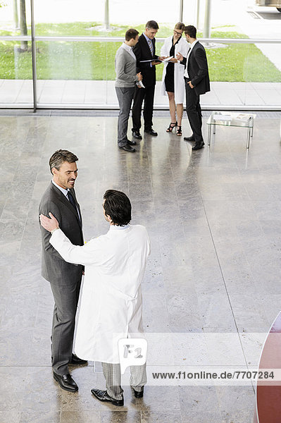 Business people and doctors greeting